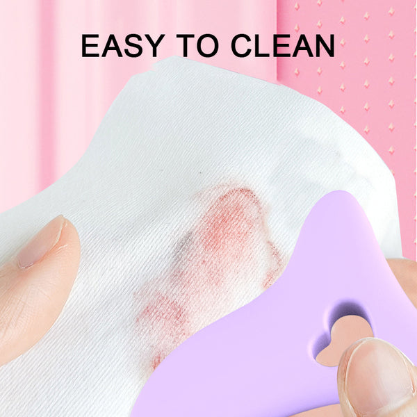 Purple curved makeup guide being wiped with a white cloth