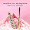 Multicolored mascara tube with open black wand in a pink gift box