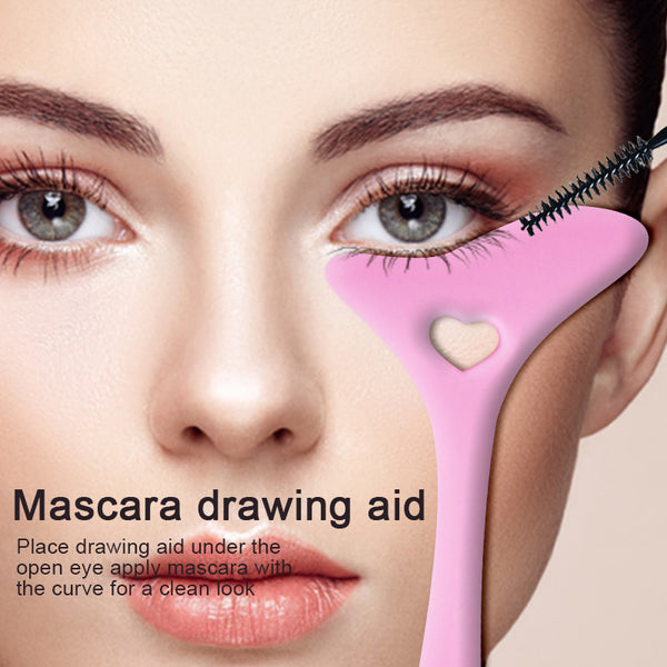 Pink curved makeup guide held below the eye during mascara application