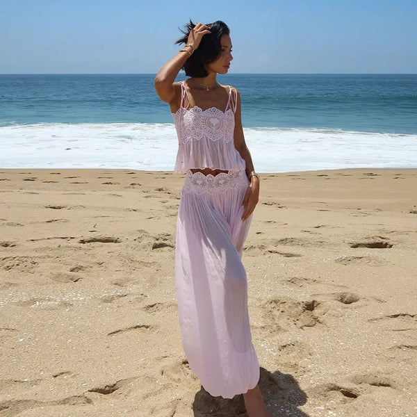 Pink pleated pants and lace-trim top, beach view