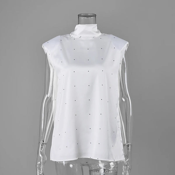White polka-dot blouse on a clear mannequin, front