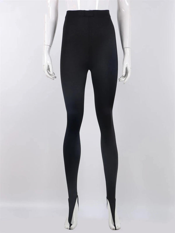 Full front view of black stirrup leggings on a white mannequin