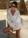 Striped knit hoodie with front pockets, seated view