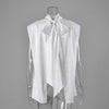 White blouse showing open back and long scarf ties
