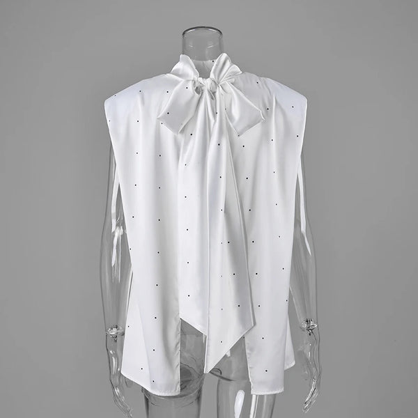 White blouse showing open back and long scarf ties