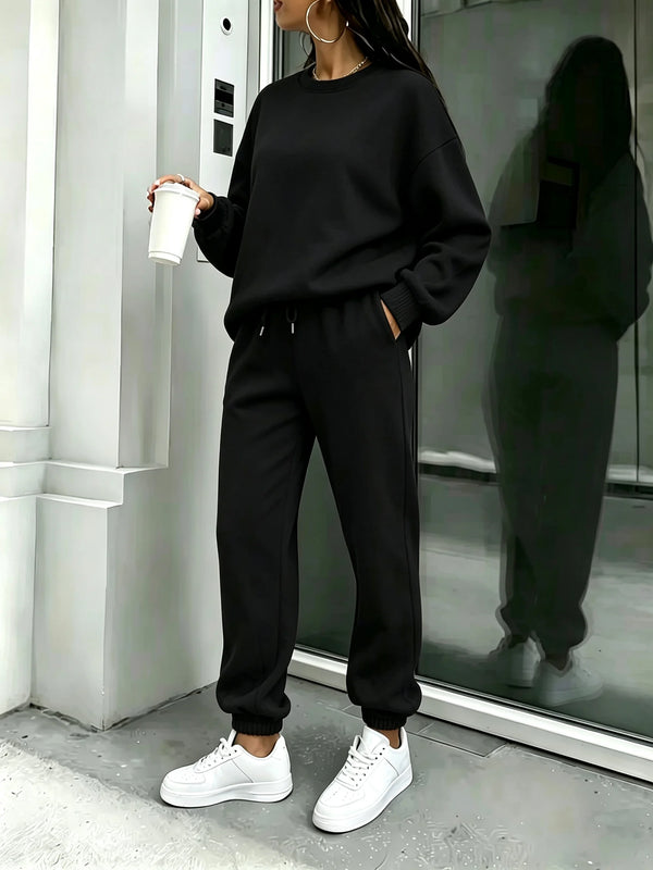 Side view of the black matching sweatshirt and joggers