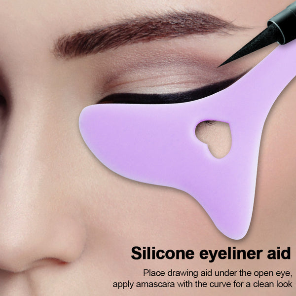 Purple makeup guide held beside the eye during eyeliner application