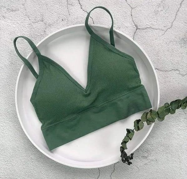 Dark green ribbed V-neck bralette displayed on a round tray