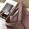 Close-up of mauve ribbed bralette fabric and narrow shoulder strap
