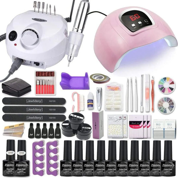 Nail art kit layout with an electric nail drill, pink dome lamp, gel bottles, files, and tools