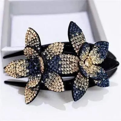 Dark blue and pale gold rhinestone flowers on a black hair claw
