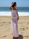Pink two-piece lace-trim outfit at the beach