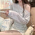 Striped long-sleeve top styled with a white skirt