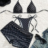 Three-piece dotted bikini set laid flat
