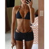 Dark polka-dot bikini worn with matching shorts