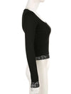 Side view of the fitted black lace-trim top