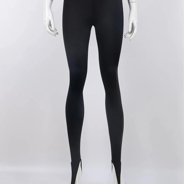 Black high-waisted stirrup leggings shown from the front on a mannequin